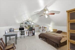The loft is open and bright with forest tree views